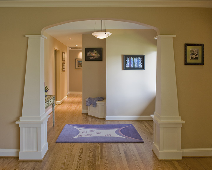 NEW ENTRY FRAMED BY CRAFTSMAN STYLED COLUMNS, ARCHED OPENING.