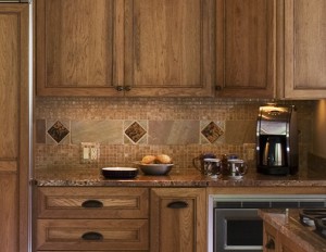 CLOSEUP BACKSPLASH TILE DETAIL TIES KITCHEN SPACE INTO LIVING ROOM FIREPLACE.