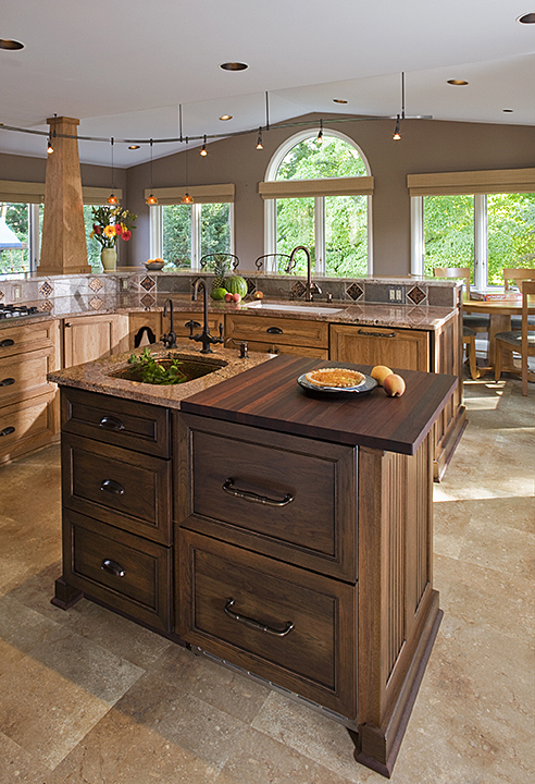 SMALL, SECOND KITCHEN ISLAND FEATURES ACCENT CABINET FINISH.