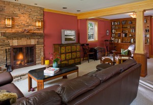 NEW FAMILY ROOM OPEN AND INVITING WITH WALL REMOVED, RESTYLED FIREPLACE. CRAFTSMAN POST CLADS BEARING COLUMN. BOOK SHELVES CREATE DISPLAY, STORAGE, AND QUIET READING CORNER.