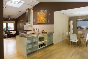 TONES OF DRAMATIC GRANITE CONNECTS TO STAINLESS STEEL AND GLASS, PROVIDES FOIL FOR CABINETS AND FLOORING.