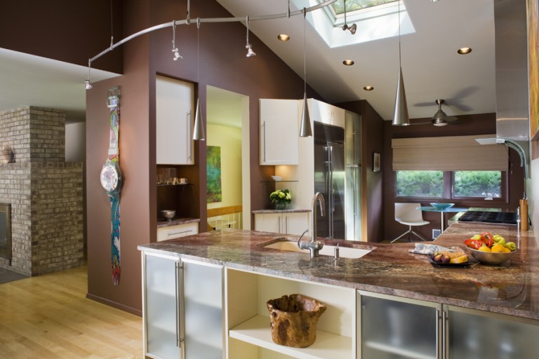 FROSTED GLASS DOORS AND OPEN CABINETS BRING DEPTH AND RHYTHM TO THE CABINET AREAS.
