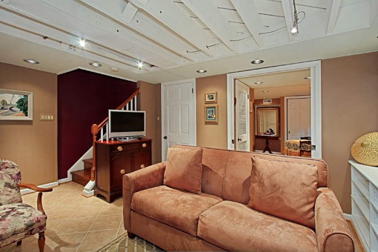 VIEW OF BASEMENT SEATING AREA AND STAIRS